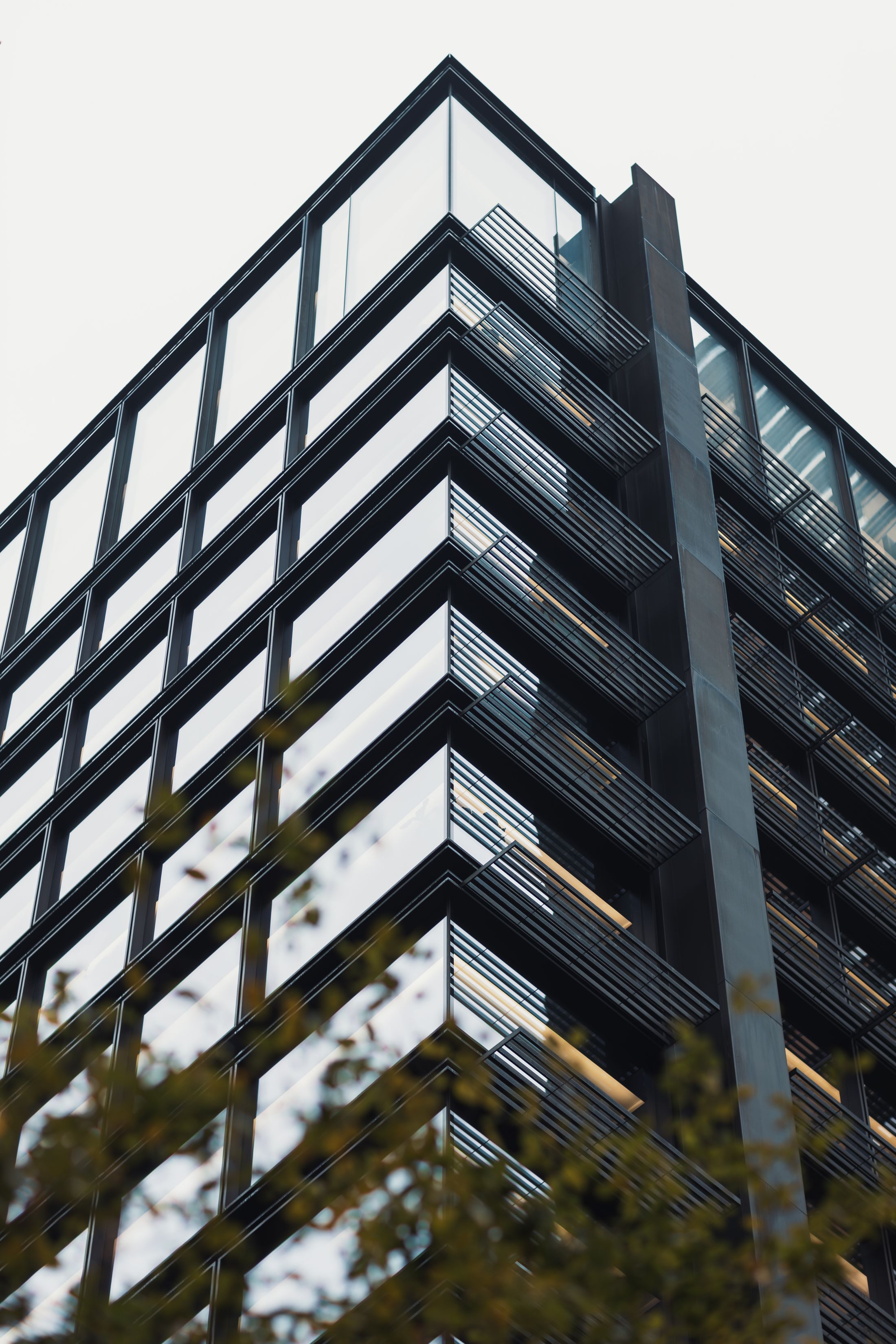 The corner of a glass office tower, used as an illustrative business image
