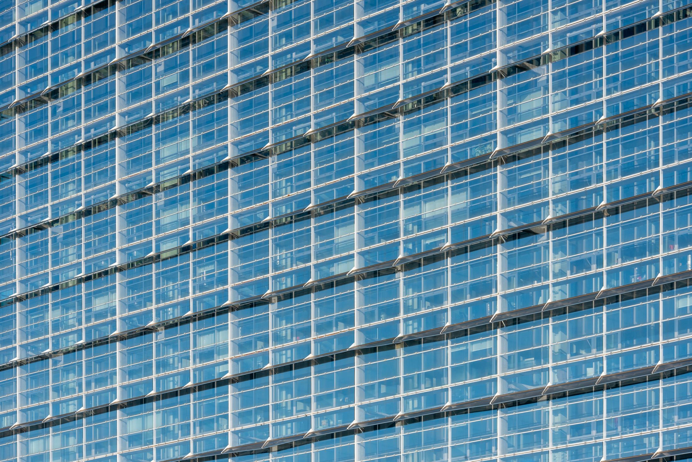 A glass curtain wall on an office building, used as an illustrative image